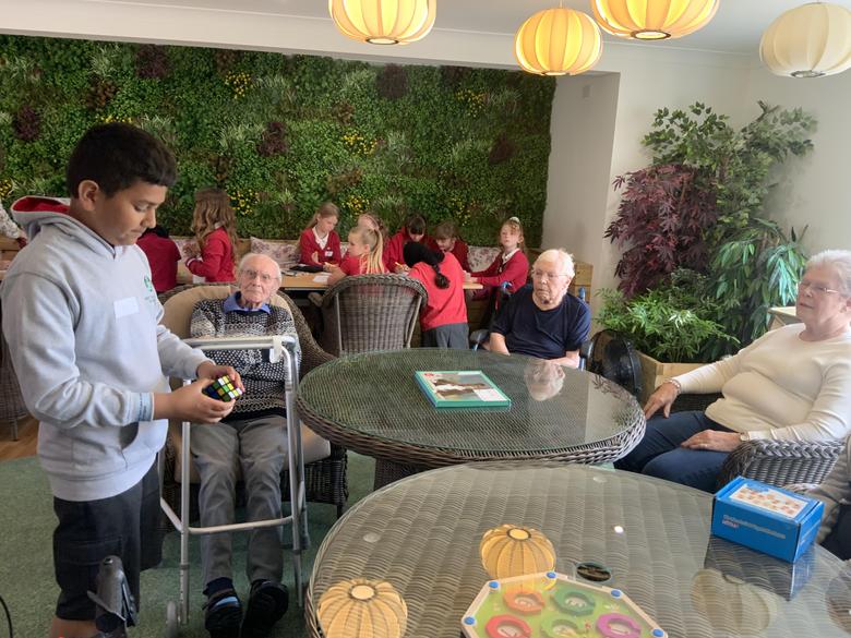 Child shares toy with elderly man